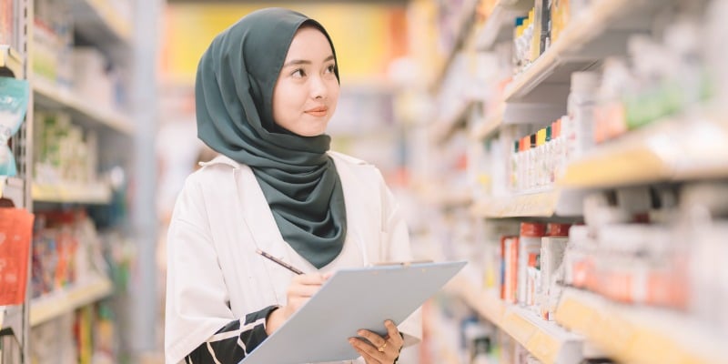 Pharmacist reviewing shelves of products