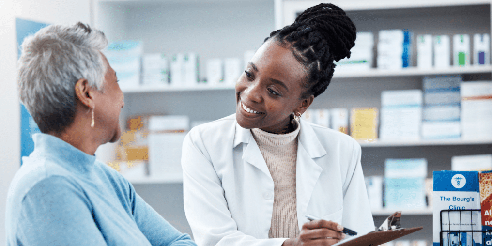Patient looking at medicinal documents with Pharmacy assistant - Understanding the Role of Pharmacy Assistants in Alberta: Your Questions Answered 